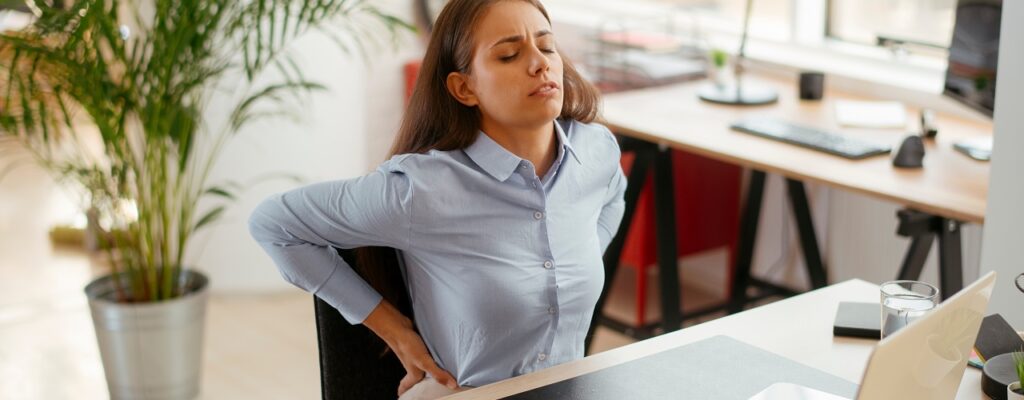 Young businesswoman having backache